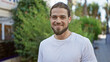 © Krakenimages.com - Young hispanic man smiling confident standing at park