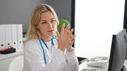 Poster - Young blonde woman doctor using computer working at clinic