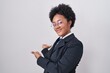 © Krakenimages.com - Beautiful african woman with curly hair wearing business jacket and glasses inviting to enter smiling natural with open hand