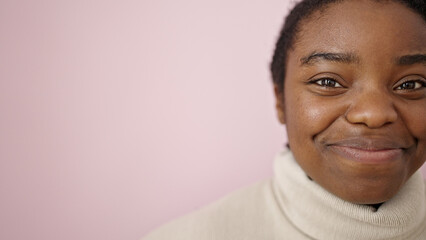 Wall Mural - African american woman smiling confident standing over isolated pink background