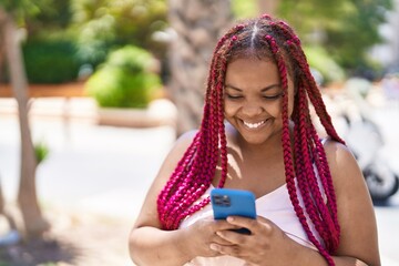 Poster - African american woman smiling confident using smartphone at street