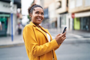 Sticker - African american woman smiling confident using smartphone at street