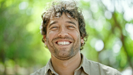 Canvas Print - Young hispanic man smiling confident standing at park