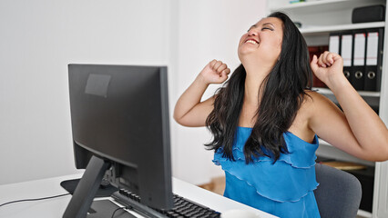 Wall Mural - Young chinese woman business worker using computer celebrating at the office