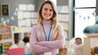 © Krakenimages.com - Young blonde woman teacher smiling confident standing with arms crossed gesture at kindergarten