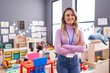 © Krakenimages.com - Young blonde woman teacher smiling confident standing with arms crossed gesture at kindergarten