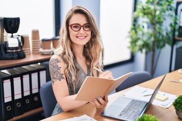 Poster - Young woman business worker using laptop writing on notebook at office