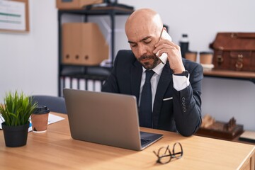 Sticker - Young bald man business worker using laptop talking on smartphone at office