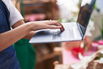 Poster - Young blonde woman florist using laptop at florist shop