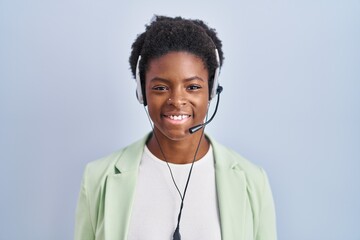 Canvas Print - African american woman wearing call center agent headset with a happy and cool smile on face. lucky person.