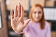 © Krakenimages.com - Young caucasian woman ecommerce business worker doing stop gesture with hand at office