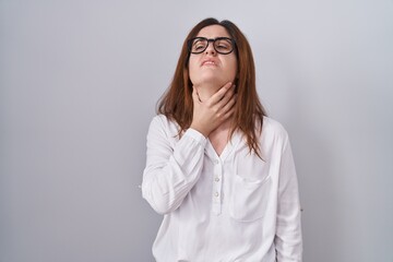 Sticker - Brunette woman standing over white isolated background touching painful neck, sore throat for flu, clod and infection