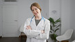 © Krakenimages.com - Young blonde woman doctor smiling confident standing with arms crossed gesture at clinic waiting room