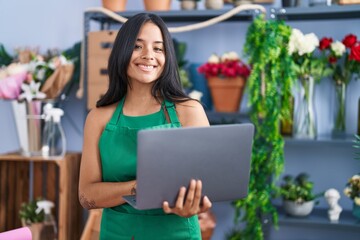 Sticker - Young hispanic woman florist smiling confident using laptop at florist shop