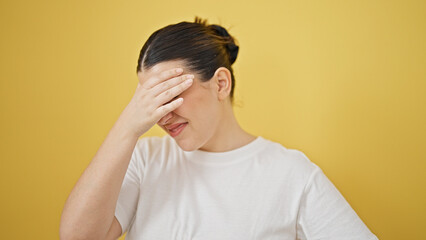 Poster - Young beautiful hispanic woman suffering for headache over isolated yellow background