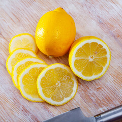 Wall Mural - Fresh lemon slices on wooden background. Vitamin cooking ingredients ..