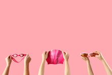 Female Hands Holding Swimming Equipment On Pink Background