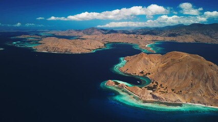 Wall Mural - Komodo National Park during sunny calm day, Flores island, Indonesia. Aerial view of the tropical islands and lagoons with turquoise water