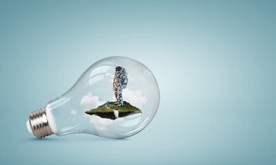 Wall Mural - spaceman inside light bulb. mixed media