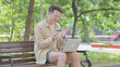 © stockbakers - Modern Young Man having Online Payment Problem on Laptop Outdoor