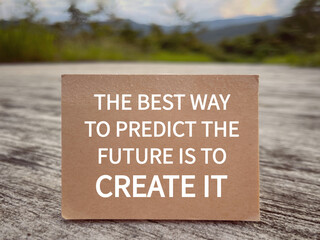 Wall Mural - Motivational and inspirational wording. The Best Way To Predict The Future Is To Create It written on a notepad. With blurred styled background.
