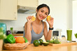 © Prathankarnpap - Young athletic woman preparing ingredients for making green vegetables detox smoothie in kitchen