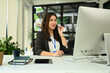 © Prathankarnpap - Charming asian female call center operator with headset working on support hotline in modern office