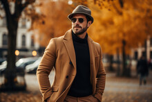 Men's Autumn Fashion.Handsome Stylish Adult Caucasian Male Model Wearing Sunglasses, Brown Coat And Hat Posing On City Street On Autumn Day, Lifestyle