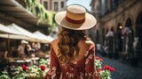 Fototapeta Uliczki - Woman in a sun hat exploring the streets of a European city