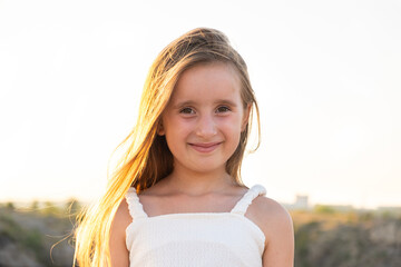 Portrait of a beautiful 5 or 6 year old girl against the sky, copy space for text