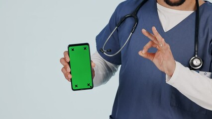 Poster - Nurse, phone green screen and okay hand for healthcare website, clinic services and yes emoji in studio. Medical person or doctor with mobile mockup and telehealth tracking marker on white background