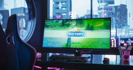  Empty Gaming Station with Video Game Victory Screen Display Standing on a Stylish Table in a Futuristic Cyberpunk Room with Neon Light. Screen of a Game Winner on an E-sports Tournament