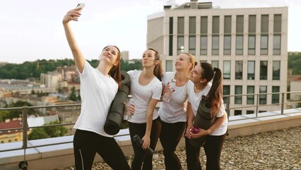 Wall Mural - Yoginis taking self-photo on mobile after outdoor exercises