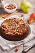 © natkinzu - Chocolate sponge cake with pears and hazelnuts. Delicious autumn homemade sweet pie with seasonal fruits.