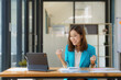 © Songsak C - An Asian businesswoman is excited and delighted to achieve their goal with a tablet computer at an office.