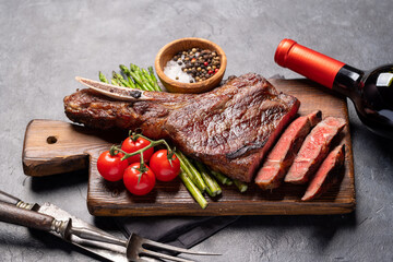 Canvas Print - Medium rare grilled Tomahawk beef steak with asparagus