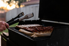 Barbecue Tongs And A Backyard Barbecue