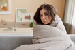 © Seventyfour - Portrait of sad young woman wrapped in blankets at home struggling with depression, copy space