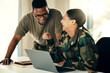 © aLListar/peopleimages.com - Laptop, friends and a military team laughing in an office on an army base camp together for training. Computer, smile or funny with a man and woman soldier working together on a winning strategy
