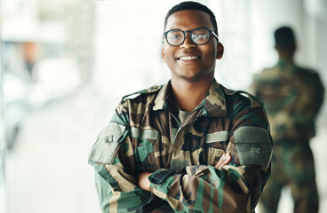 Wall Mural - Confident soldier portrait, smile and arms crossed in army building, pride and professional hero service. Military career, security and courage, black man in camouflage uniform at government agency.