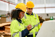 © FotoArtist - Industrial worker indoors in factory. Young technician with orange hard hat. Smart Caucasian factory worker wearing hardhat and working in power plant.