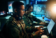 © aLListar/peopleimages.com - Military control room, computer and soldier at desk, typing code and tech for communication army office. Security, global surveillance and black man at laptop in government cyber data command center.