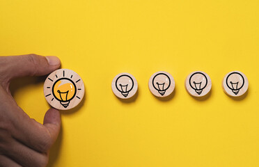 Poster - Hand holding glowing lightbulb move out from lamp icon  for creative thinking idea innovation and problem solving solution concept.