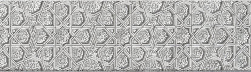 Wall Mural - Geometric traditional Islamic ornament. Fragment of a carved mosaic on white marble.