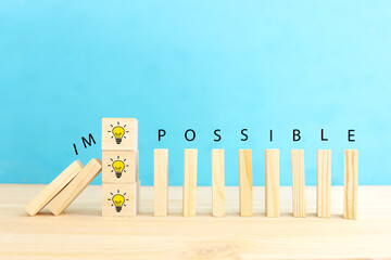 Poster - Wooden cubes with the text impossible, stopping the domino effect. success and challenge concept