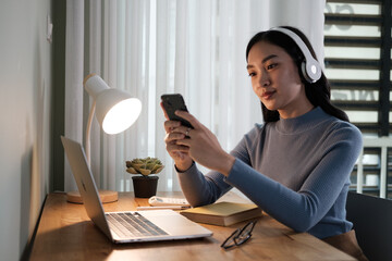 Poster - Cheerful young Chinese business woman talking on phone working in modern office.
