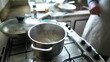 © Marco - Close-up of boiling water inside metal pan in kitchen stove, preparing food routine