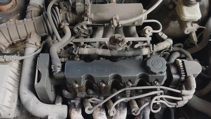 Poster - dirty car engine under the hood of the car.