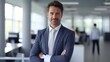 © WS Studio 1985 - leader in business smiles and looks into the camera while standing in his office. Male corporate executive manager CEO posing for a professional portrait while with his arms folded. generative ai