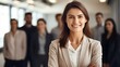 © WS Studio 1985 - happy businesswoman standing with her arms crossed in front of a business team at the office